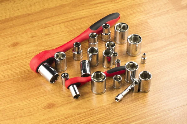 Ratchet and a set of different attachments to tighten the bolts