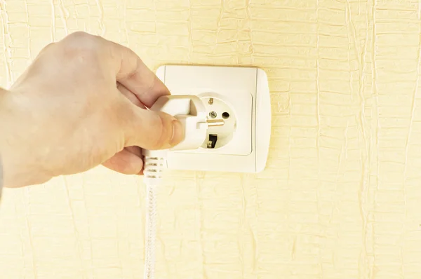 The process of connecting the white plug into the socket
