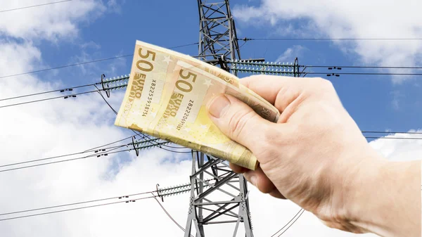 The euro in hand on the background of power lines
