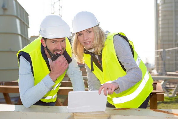 Workers on a construction studying blueprints