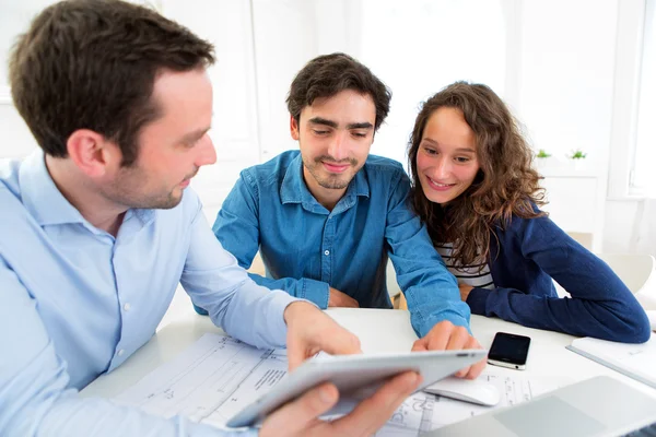 Young serious couple meeting a real estate agent