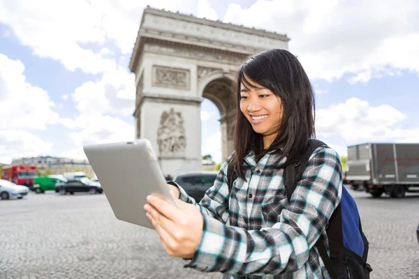 Young attractive asian tourist using tablet in Paris