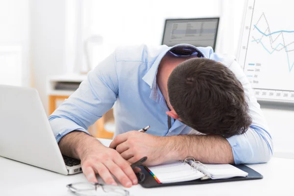 Young attractive man too tired to work