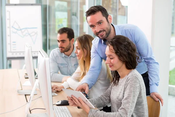 Young attractive people taking a training course with formator