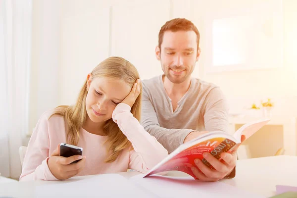 Father helping out her daughter for homework