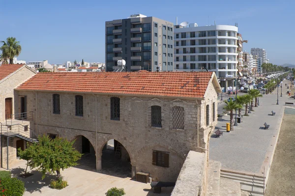 The old customs building in the Fort on the background of modern buildings. Larnaca, Cyprus