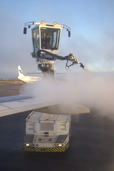 Deicing treatment of an airplane wing at Helsinki Airport