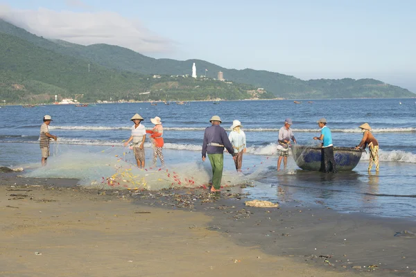 A group of fishermen dismantle the network before going fishing. Da Nang, Vietnam