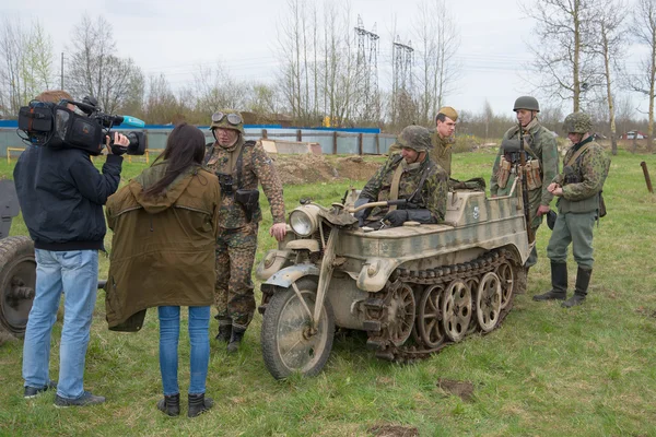 Journalists interviewing members of the military-historical club after the reconstruction of the great Patriotic war