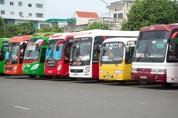 Multi-colored long-distance buses are on the landing of passengers at the bus station of the city of Vung Tau. Vietnam