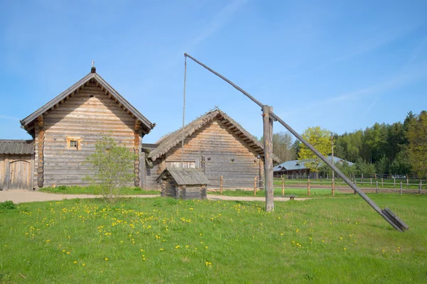 Ancient well on wooden farmhouses. Reconstruction of a farm of the XVIII century in the village Bugrovo. Pushkin Hills