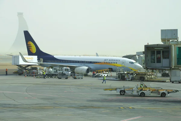 Boeing 737 Next Gen Jet Airways undergoes pre-flight preparation at the airport of Abu Dhabi in the early morning