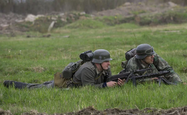 Two Wehrmacht soldiers lying on the grass. Reconstruction episode of the great Patriotic war