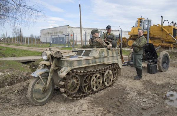 Members of military-historical club in the form of a German soldier and motorcycle-tractor 