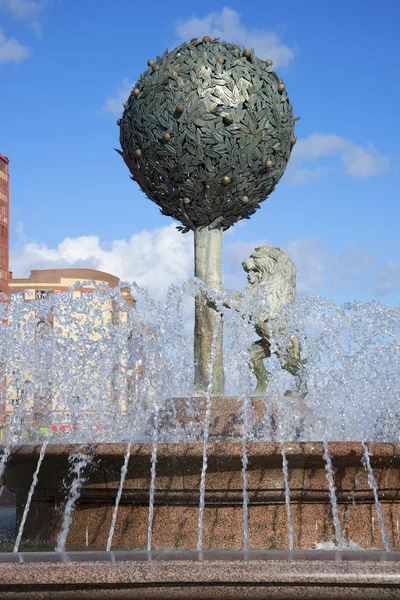 Of orange tree and a lion in the jets of water. Sculpture in the center of the fountain in the town of Lomonosov