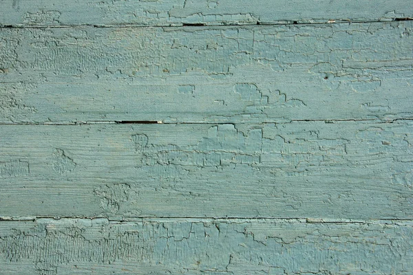 Light blue wooden planks with peeling paint, texture
