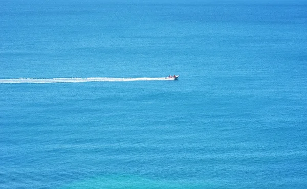Small power boat on turquoise portuguese Sea