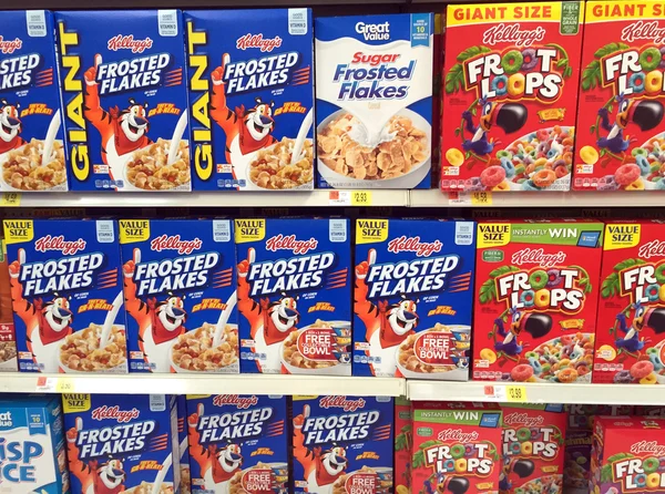 Several boxes of breakfast cereal on a store shelf