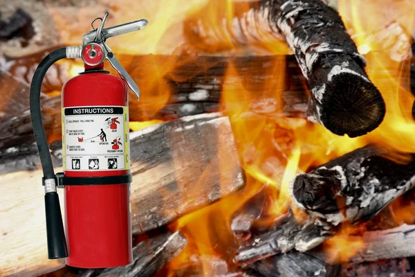 Fire extinguisher with a fire background