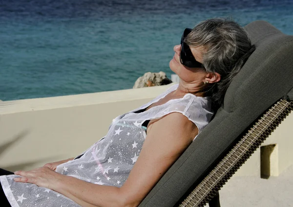 Woman resting on a patio chair