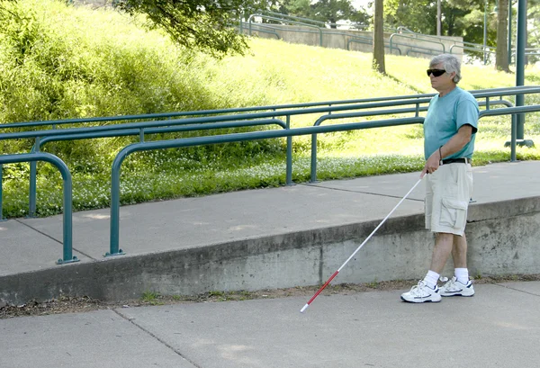 Disabled blind man with walking cane