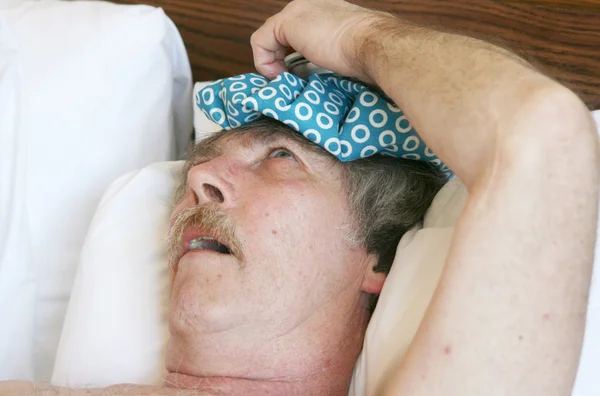 Man With a Headache and an Ice Bag on his Head