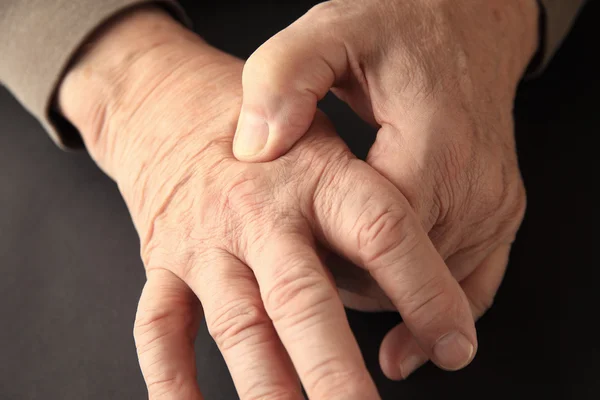 Joint pain on hand of older man