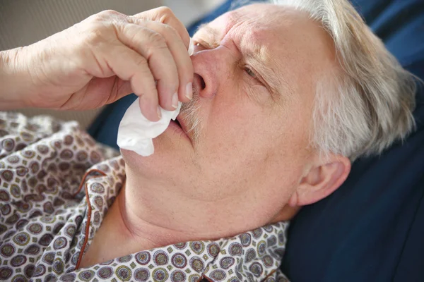 Older man suffers from bad cold.