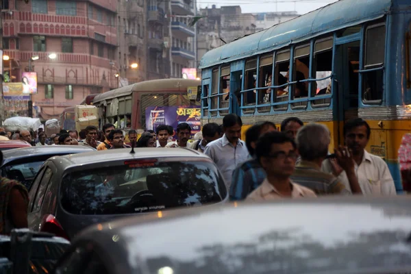 Dark city traffic blurred in motion at late evening on crowded streets in Calcutta