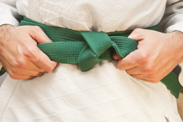 Aikido green belt on white kimono