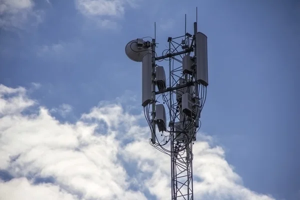 Telecommunications tower isolated on sky