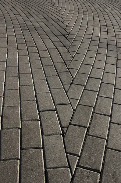 Background of cobble cement block stones road making of abstract arrow sign