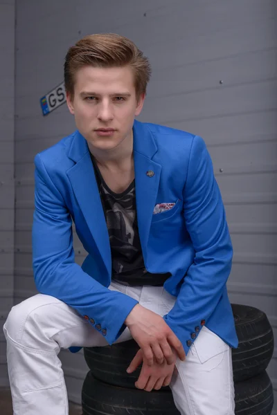 Portrait of a young man in the car garage