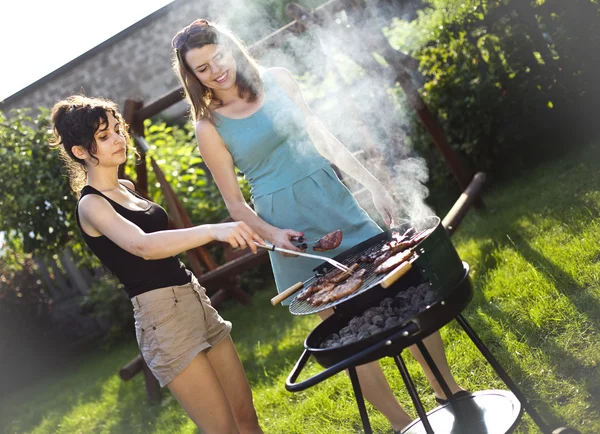 Girls making food on grill