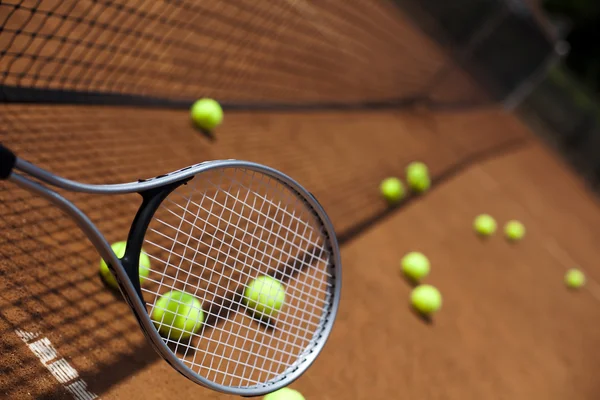 Tennis racket with tennis balls