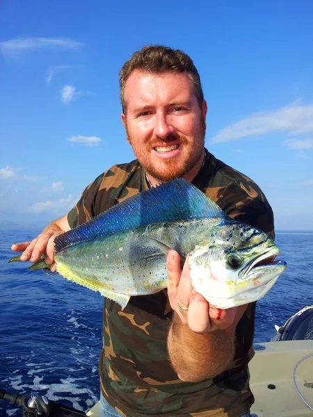 Fisherman holding a dolphin fish