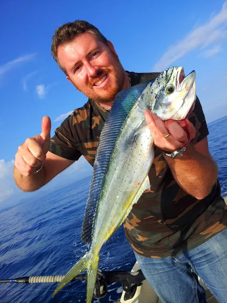 Fisherman holding a dolphin fish