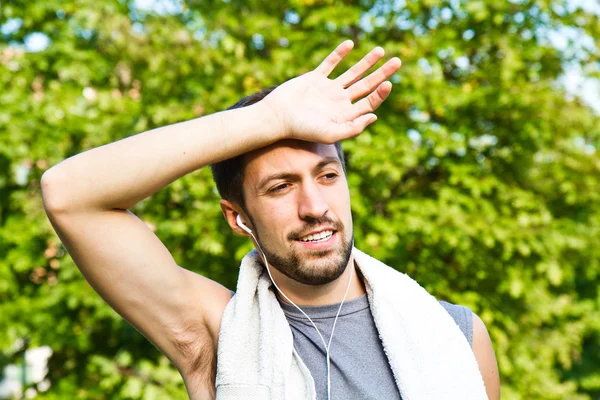 Young man jogging in park. Health and fitness.