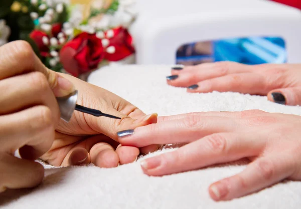 Manicure and Hands with uv lamp for nails