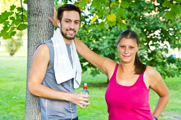 A couple drinking water after sport