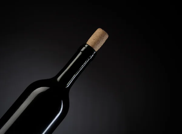 Wine bottle on dark studio background photo