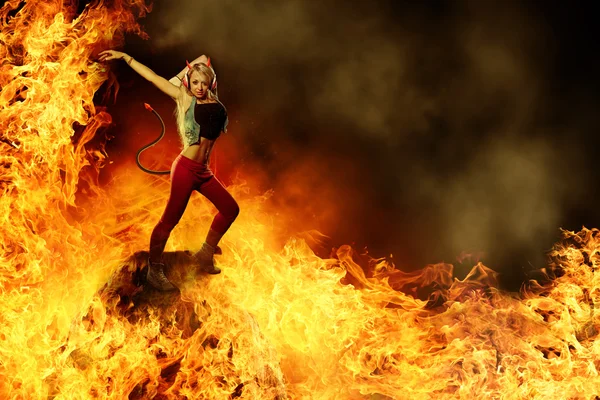 Blonde female devil is dancing in the fire