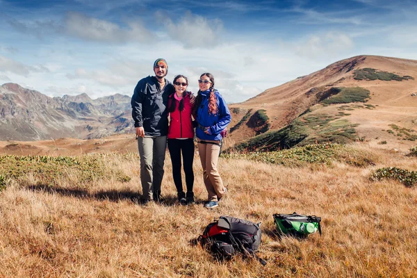 Happy group of friends on excursion in the nature having fun and smiling and posing to the camera