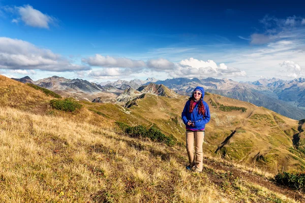 Hiking - hiker woman on trek living healthy active lifestyle. Hiker girl walking on hike in mountain nature landscape in Caucasus mountains, Abkhazia and Russia