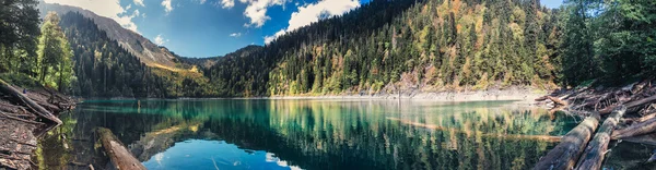 Beautiful panoramic view of Small Ritsa mountain lake in Ritsa National Park on a sunny summer day, Abkhazia