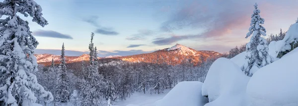 Panorama of winter red mountains on the sunset