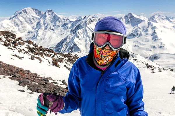Happy girl dressed in ski or snowboard fashion mask goggles. Mountain landscape. Extreme adventure. Winter ski resort