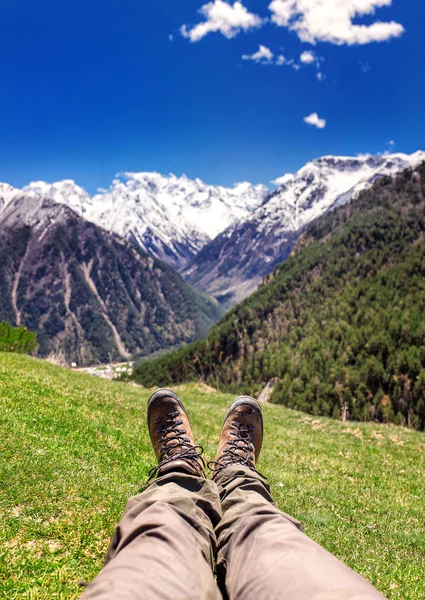 Hiking boots in the mountains. Resting time and travel concept