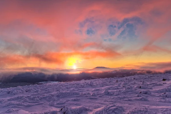 Winter landscape in mountains at sunrise