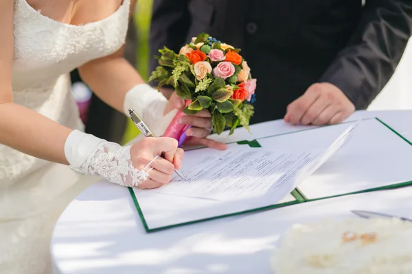 Bride signing marriage license